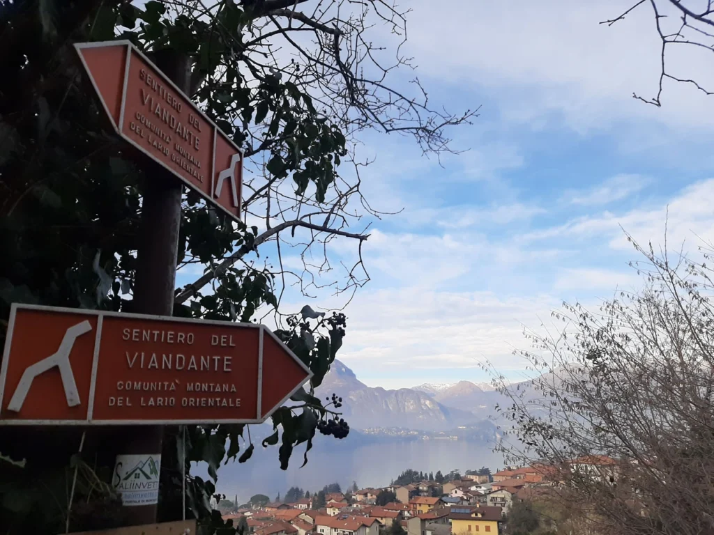 Path signs and view of Lierna